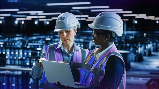 Engineers looking at laptop in Data Center